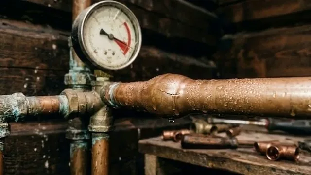 Pressure gauge on cold copper water line, during a leak detection visit in Apache Junction, Arizona.