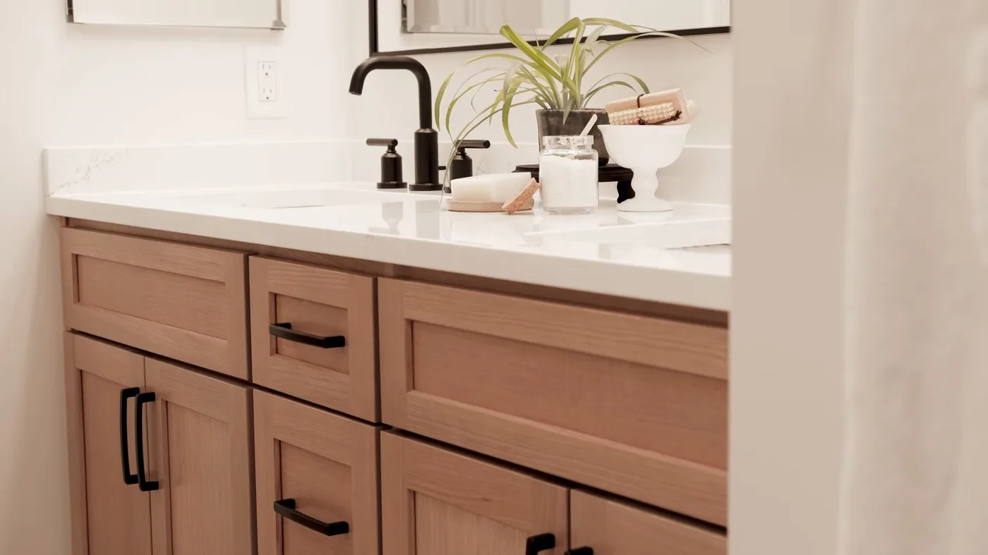 Wood vanity and bathroom sink after remodel, photographed on an emergency plumbing call near Apache Junction, AZ.